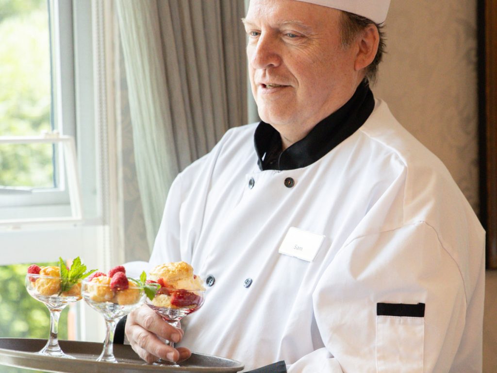 chef holding desserts on a tray